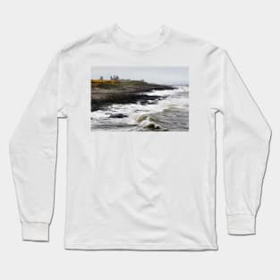 Dunstanburgh castle with rough waves battering the coast in Northumberland, UK Long Sleeve T-Shirt